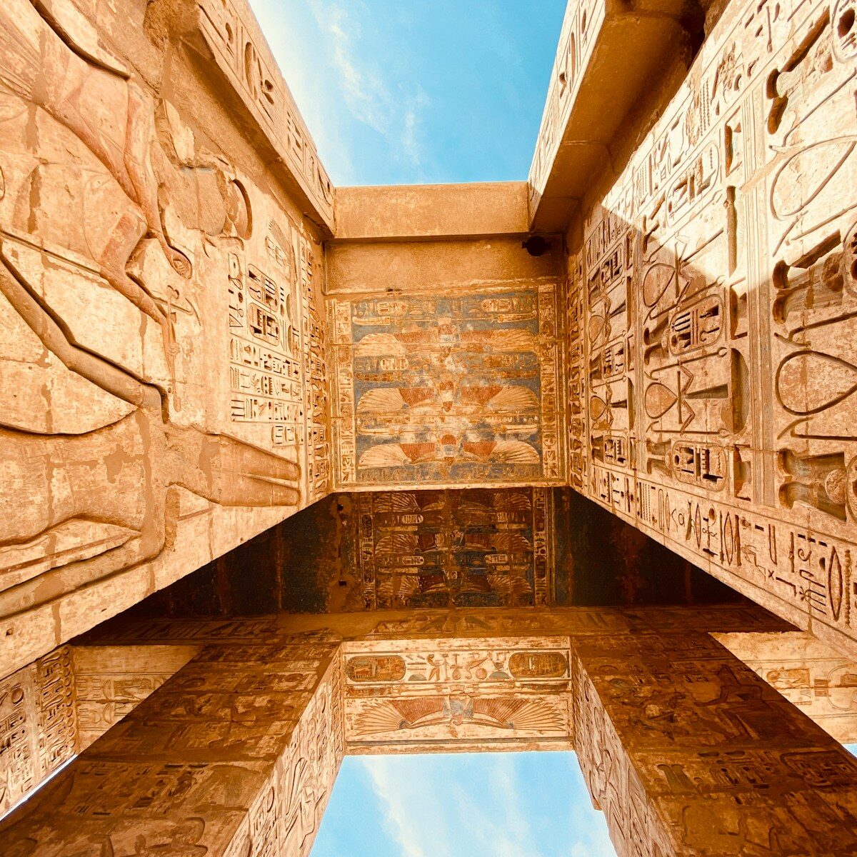 low angle photography of brown concrete building under blue sky during daytime